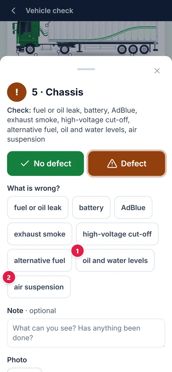 The chassis zone in an Irish workspace: the defect list includes oil and water levels and air suspension.